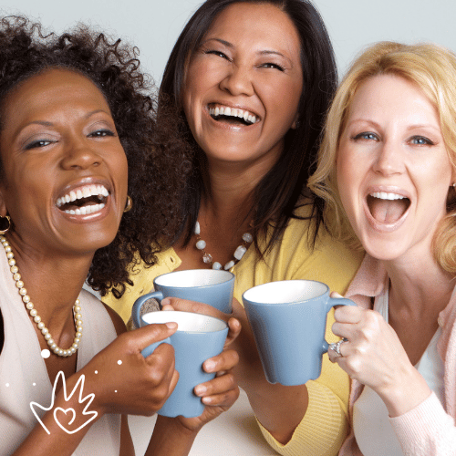 picture is of three women holding mugs and laughing together